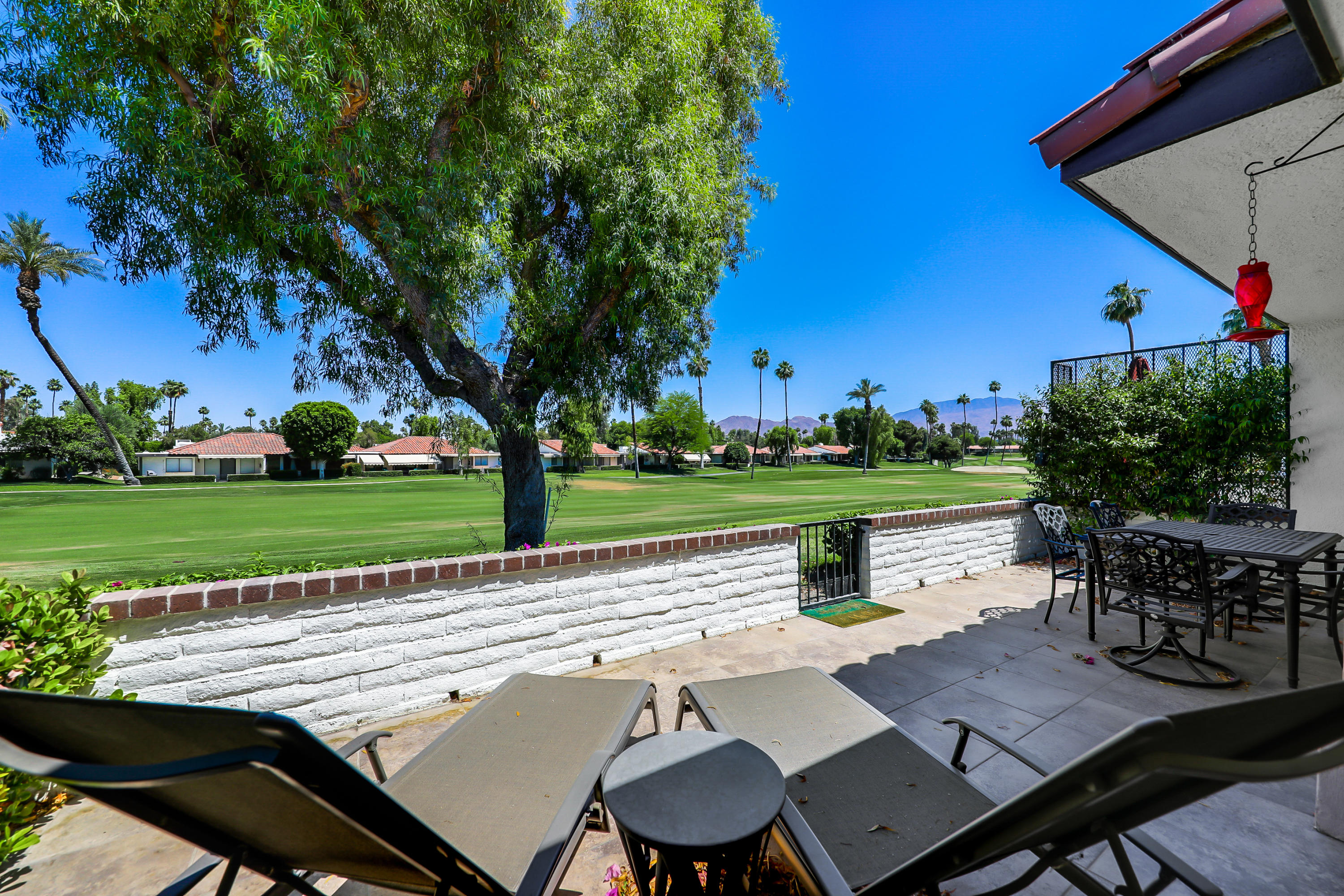 29 Leon Way Rancho Mirage, CA 92270 - Photo 16 of 17 a view of a patio with table and chairs and potted plants