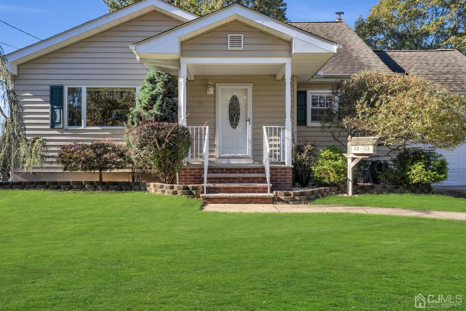 39 Latham Circle Sayreville, NJ 08859 - Photo 2 of 31 a front view of a house with a yard