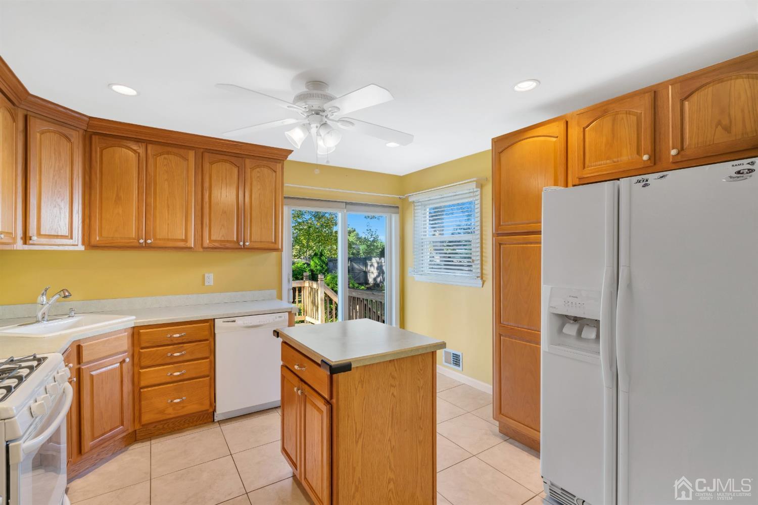 39 Latham Circle Sayreville, NJ 08859 - Photo 11 of 31 a kitchen with a refrigerator a sink and cabinets
