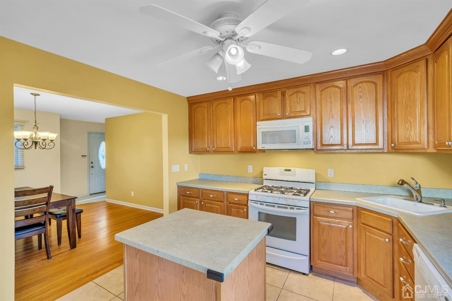 39 Latham Circle Sayreville, NJ 08859 - Photo 13 of 31 a kitchen with stainless steel appliances granite countertop a stove a sink dishwasher and a refrigerator with wooden floor