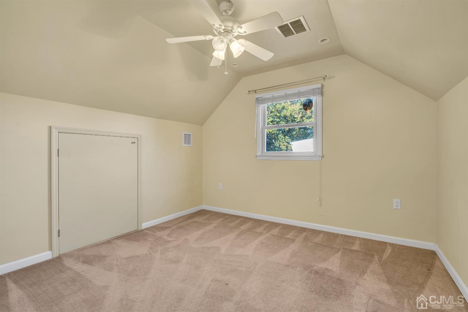 39 Latham Circle Sayreville, NJ 08859 - Photo 18 of 31 an empty room with windows and fan