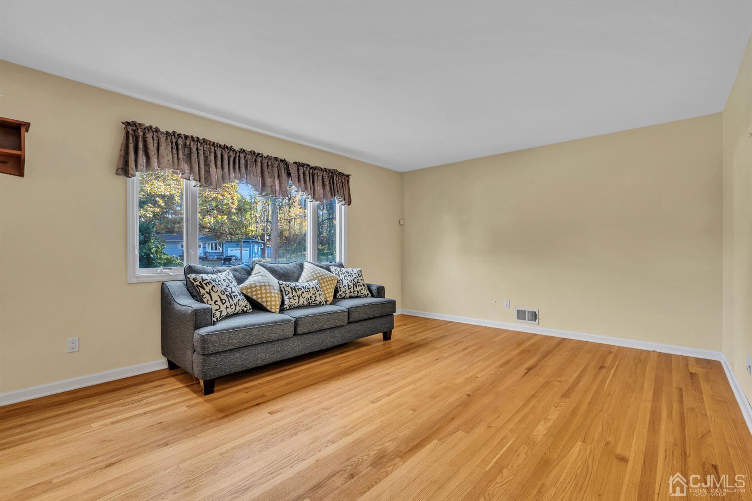 39 Latham Circle Sayreville, NJ 08859 - Photo 7 of 31 a living room with furniture and a large window