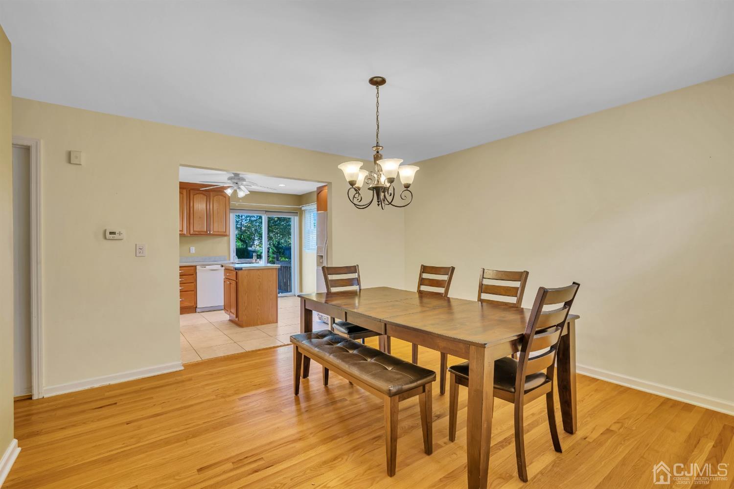 39 Latham Circle Sayreville, NJ 08859 - Photo 8 of 31 a dining room with wooden floor a chandelier a wooden table and chairs