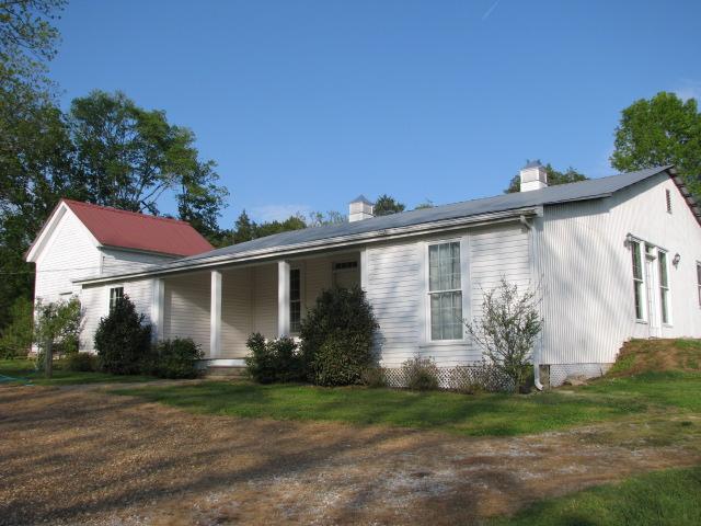 38 Crystal Ridge Road Mulberry, TN 37359 - Photo 20 of 20 a view of a white house next to a yard with potted plants