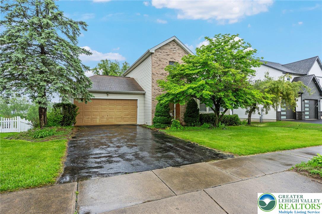 a front view of a house with a yard and a garage