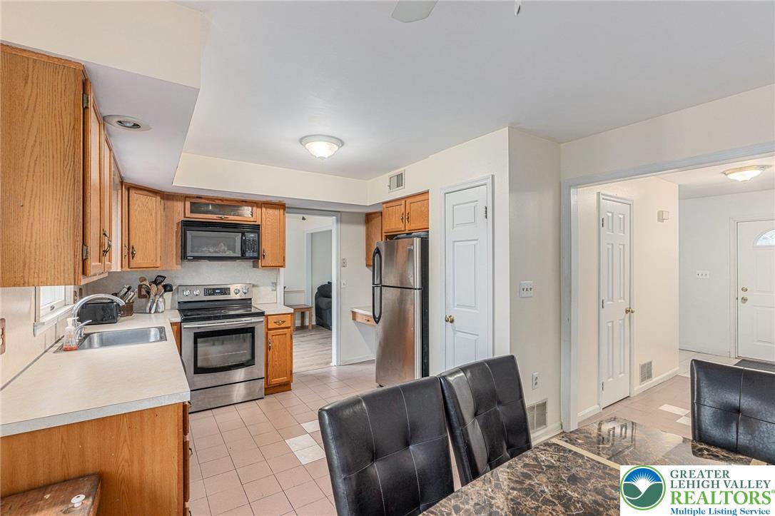 271 Maple Street Coplay, PA 18037 - Photo 11 of 25 a living room with stainless steel appliances furniture a flat screen tv and a window
