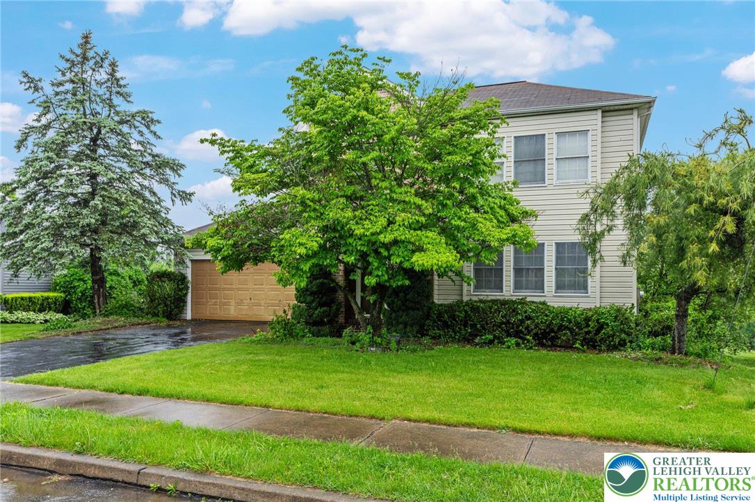 271 Maple Street Coplay, PA 18037 - Photo 2 of 25 a front view of a house with a garden and yard