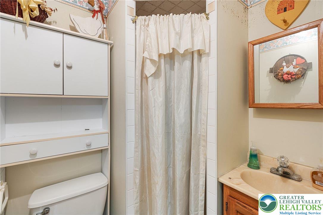 271 Maple Street Coplay, PA 18037 - Photo 22 of 25 a bathroom with a shower curtain and a sink
