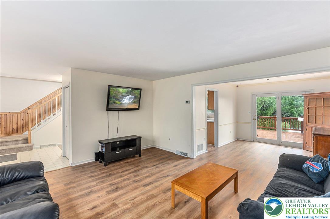 271 Maple Street Coplay, PA 18037 - Photo 6 of 25 a bedroom with a bed and a couch next to a window