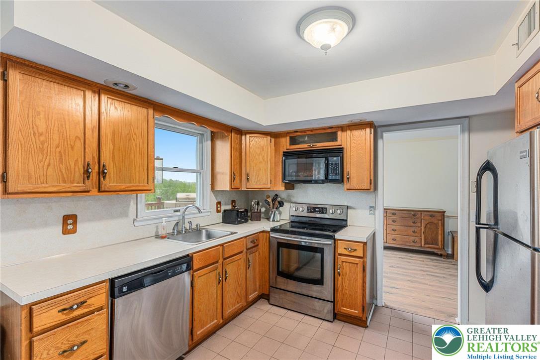 271 Maple Street Coplay, PA 18037 - Photo 10 of 25 a kitchen with stainless steel appliances a stove sink and refrigerator