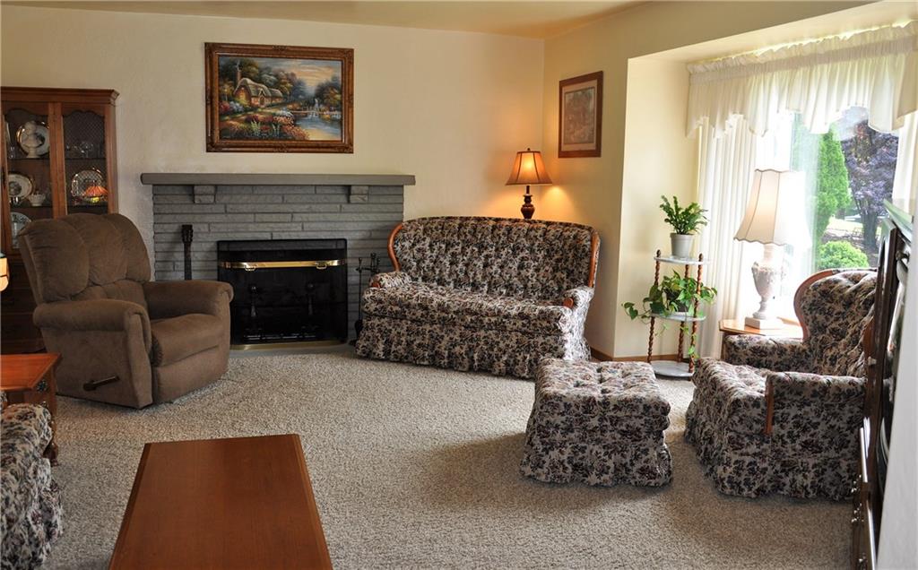 132 Siebert Road Pittsburgh, PA 15237 - Photo 11 of 23 Living room, featuring the gas log burning fireplace, original hardwood flooring under carpet.(17x16)