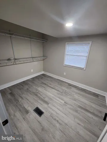 a view of a room with wooden floor