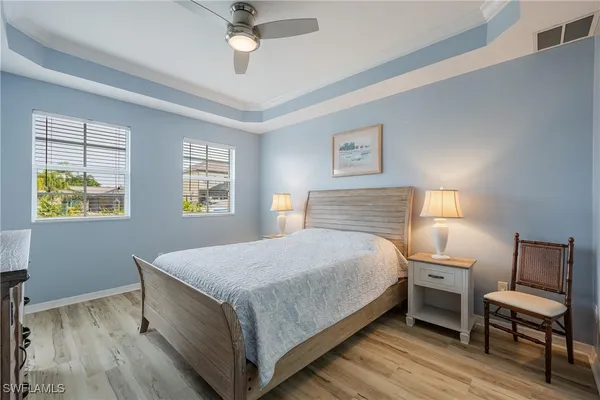 a bed sitting in a bedroom next to a lamp