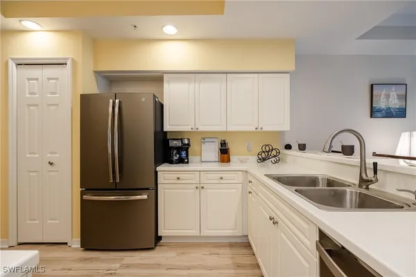 a kitchen with a sink stainless steel appliances and cabinets