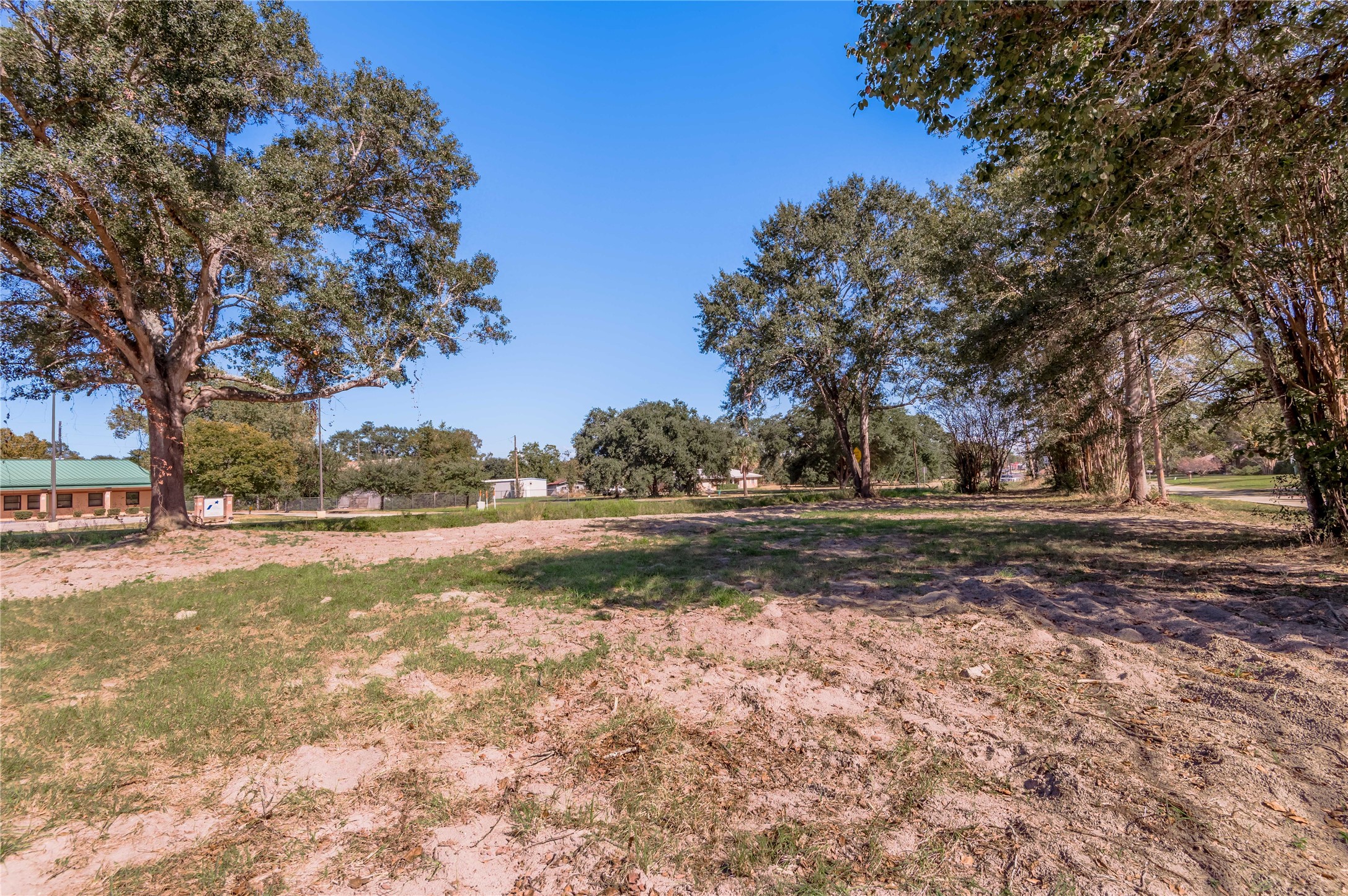 a view of dirt yard with a fountain