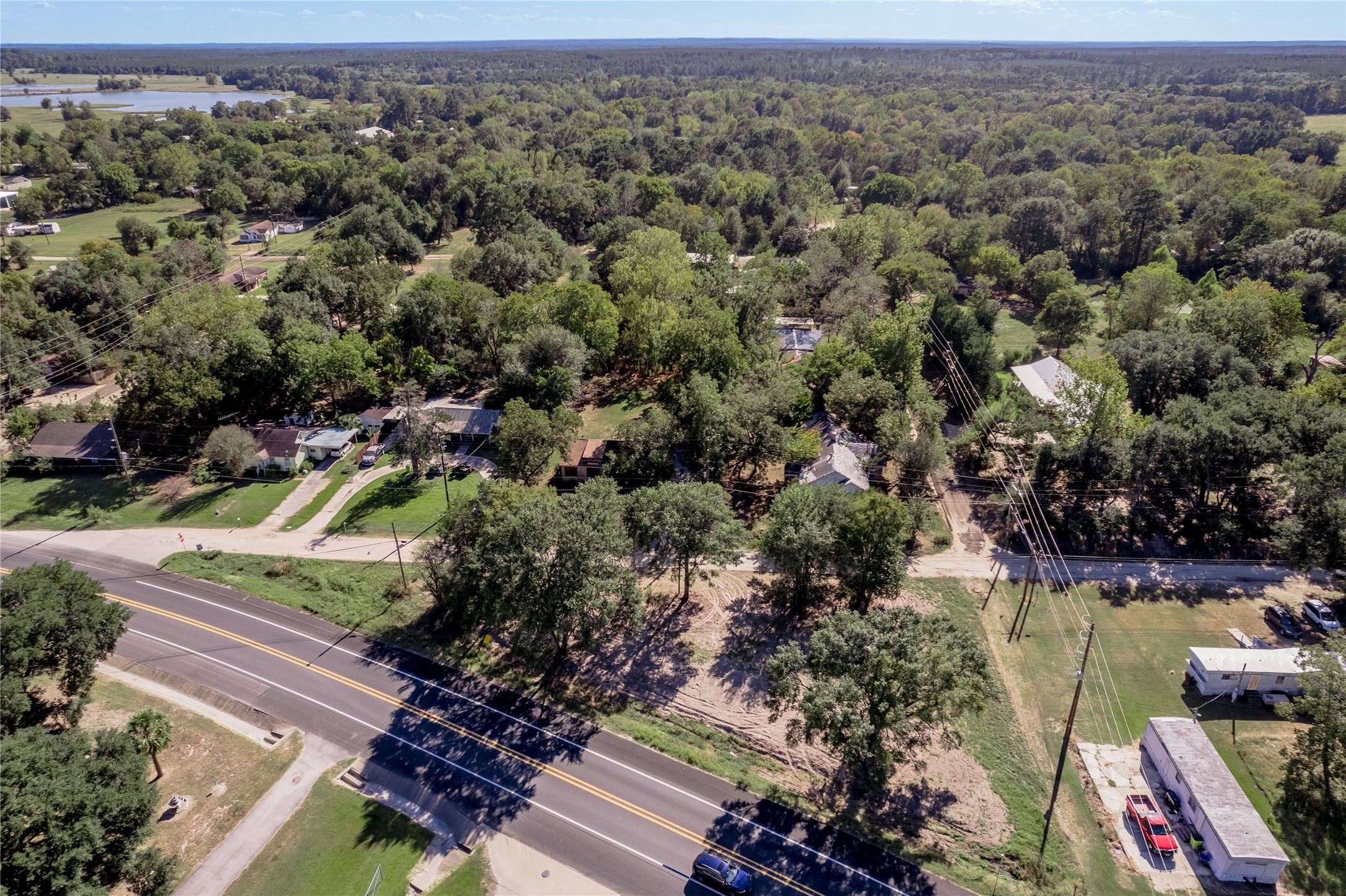 805 East 1st Street Groveton, TX 75845 - Photo 8 of 10 an aerial view of residential houses with outdoor space and trees