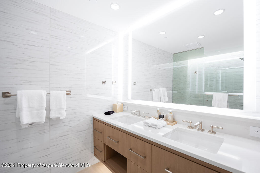 130 Wood Road, Unit 464 Snowmass Village, CO 81615 - Photo 11 of 19 a bathroom with a double vanity sink and mirror