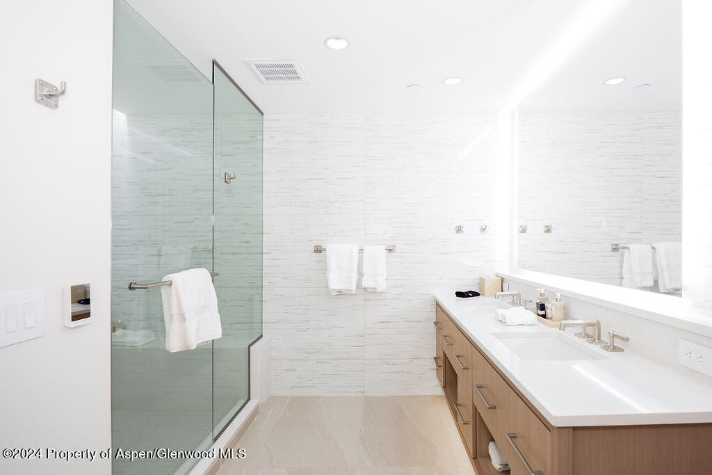 130 Wood Road, Unit 464 Snowmass Village, CO 81615 - Photo 12 of 19 a bathroom with a double vanity sink mirror and shower