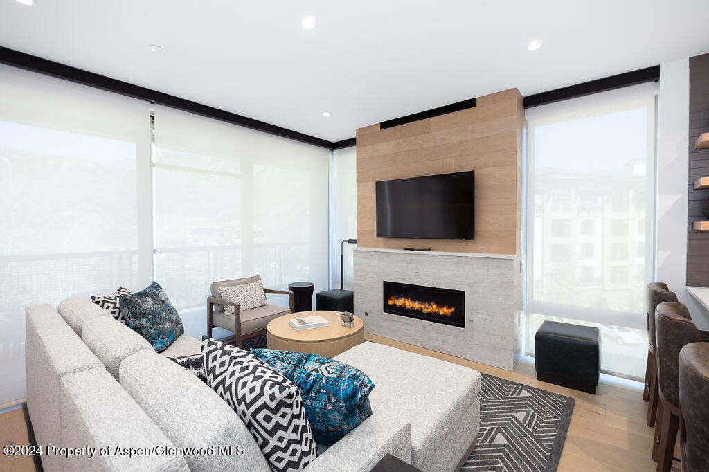 130 Wood Road, Unit 464 Snowmass Village, CO 81615 - Photo 3 of 19 a living room with furniture a fireplace and a flat screen tv