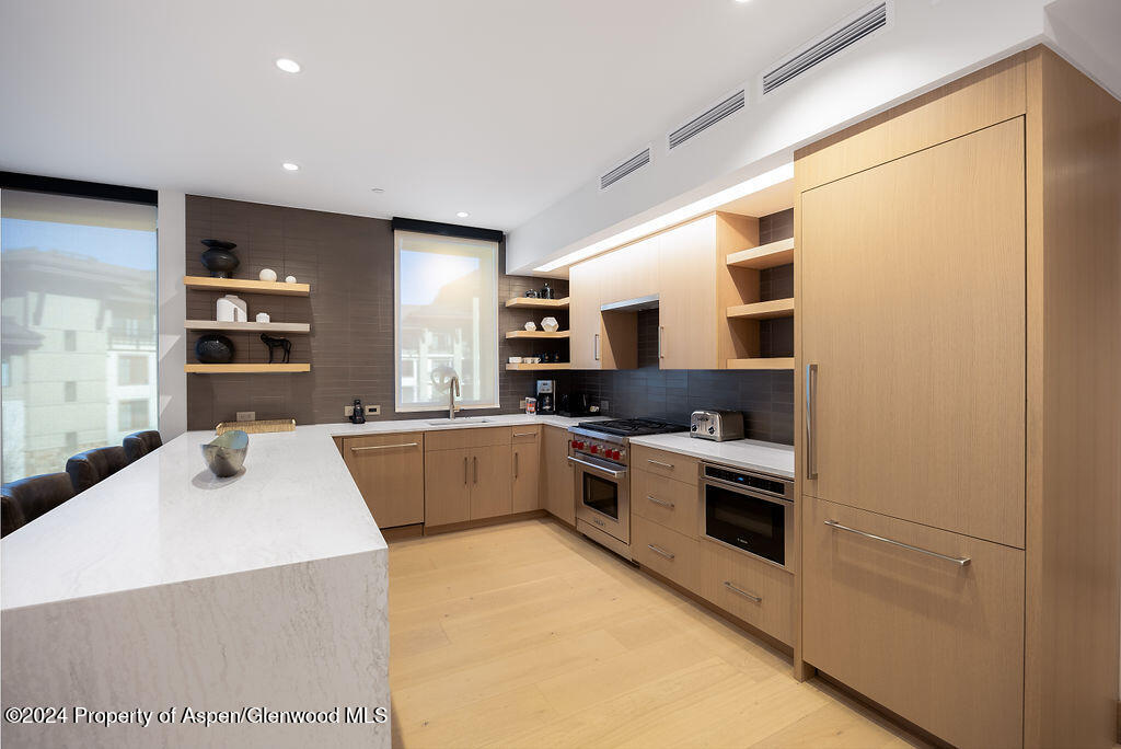 130 Wood Road, Unit 464 Snowmass Village, CO 81615 - Photo 5 of 19 a large kitchen with kitchen island a sink stainless steel appliances and cabinets