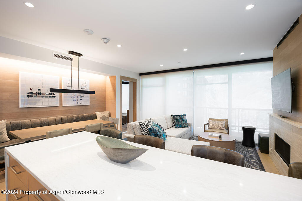 130 Wood Road, Unit 464 Snowmass Village, CO 81615 - Photo 7 of 19 a living room with furniture a flat screen tv and a large window