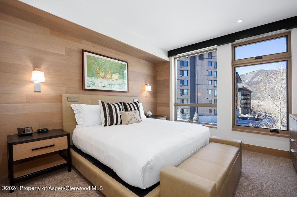 130 Wood Road, Unit 464 Snowmass Village, CO 81615 - Photo 9 of 19 a spacious bedroom with a large bed and a large window