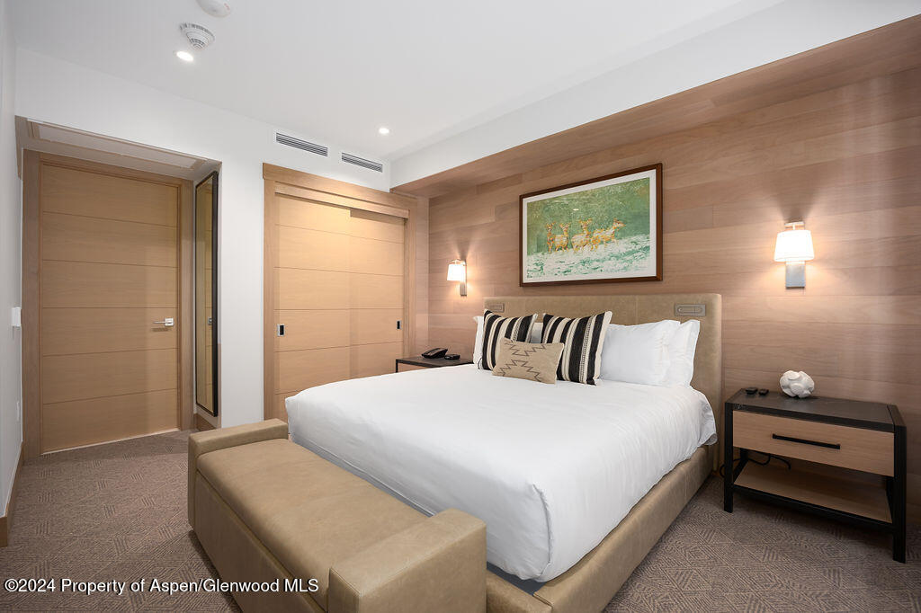 130 Wood Road, Unit 464 Snowmass Village, CO 81615 - Photo 10 of 19 a bedroom with a bed and a night stand