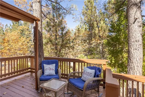 a view of a chair and table on the deck