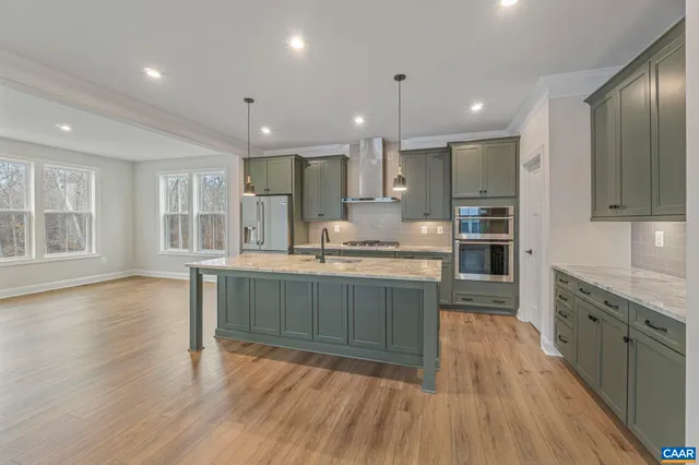 a kitchen with stainless steel appliances granite countertop a stove a sink a refrigerator and a oven