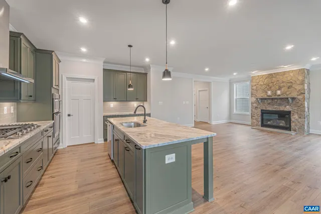 a kitchen with sink stove and refrigerator