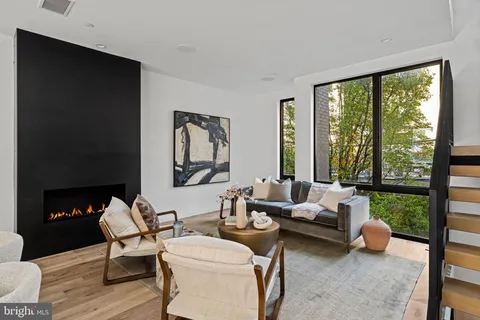 a living room with furniture and a floor to ceiling window