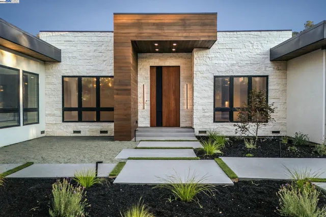 a front view of a house with a garden