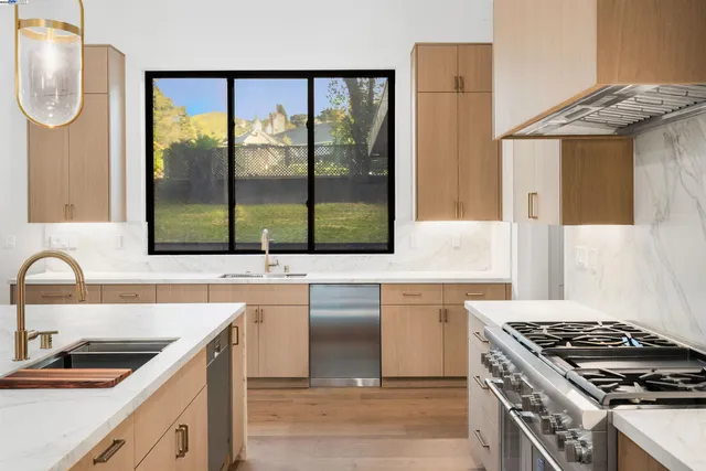 a kitchen with a sink and a stove top oven