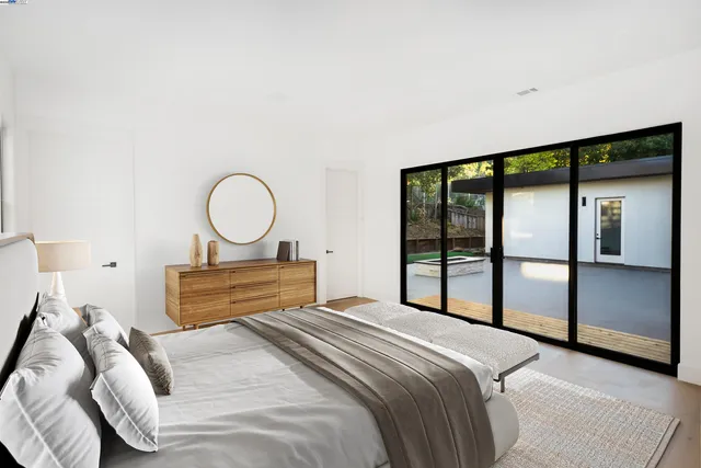 a bedroom with a large bed and a large window