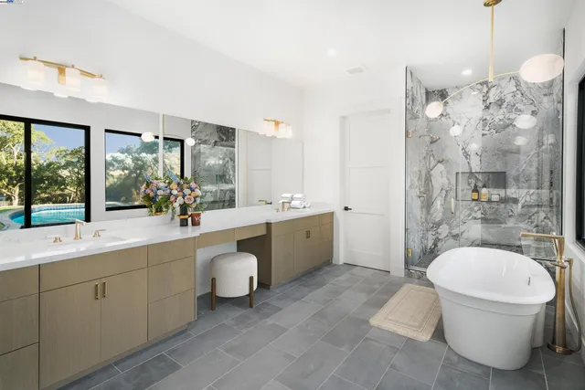 a bathroom with a double vanity sink a toilet a mirror and shower