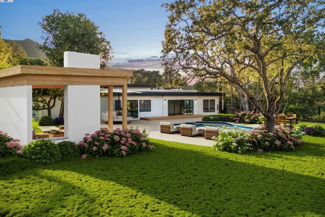 a front view of house with a garden