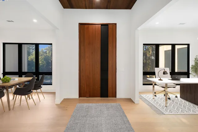 a living room with furniture and large windows