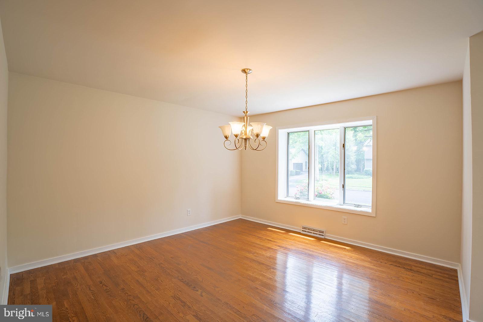 491 Kings Road Yardley, PA 19067 - Photo 12 of 52 a view of a room with wooden floor chandelier and windows