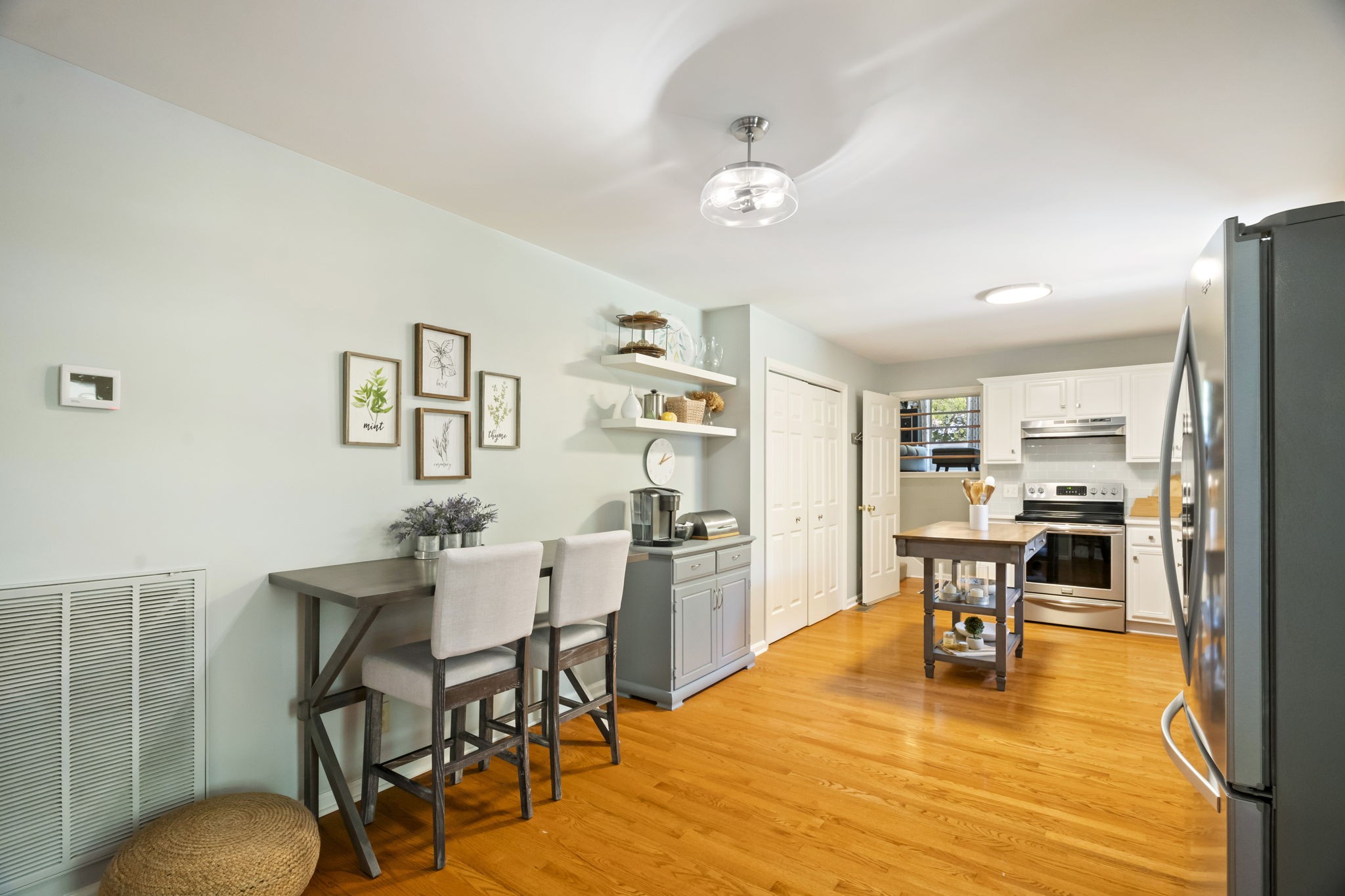 4926 Mt Zion Road Springfield, TN 37172 - Photo 21 of 48 a dining room with stainless steel appliances kitchen island granite countertop a refrigerator a stove a dining table and chairs with wooden floor