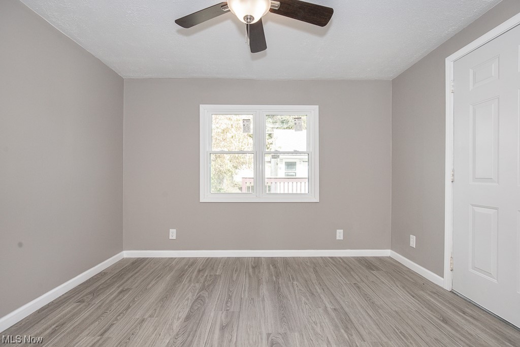 19109 Libby Road Maple Heights, OH 44137 - Photo 5 of 32 Empty room with light wood-type flooring and ceiling fan