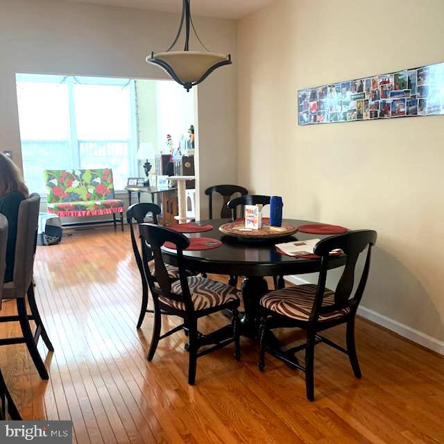 4097 River Forth Drive Fairfax, VA 22030 - Photo 4 of 18 a dining room with furniture a rug and wooden floor