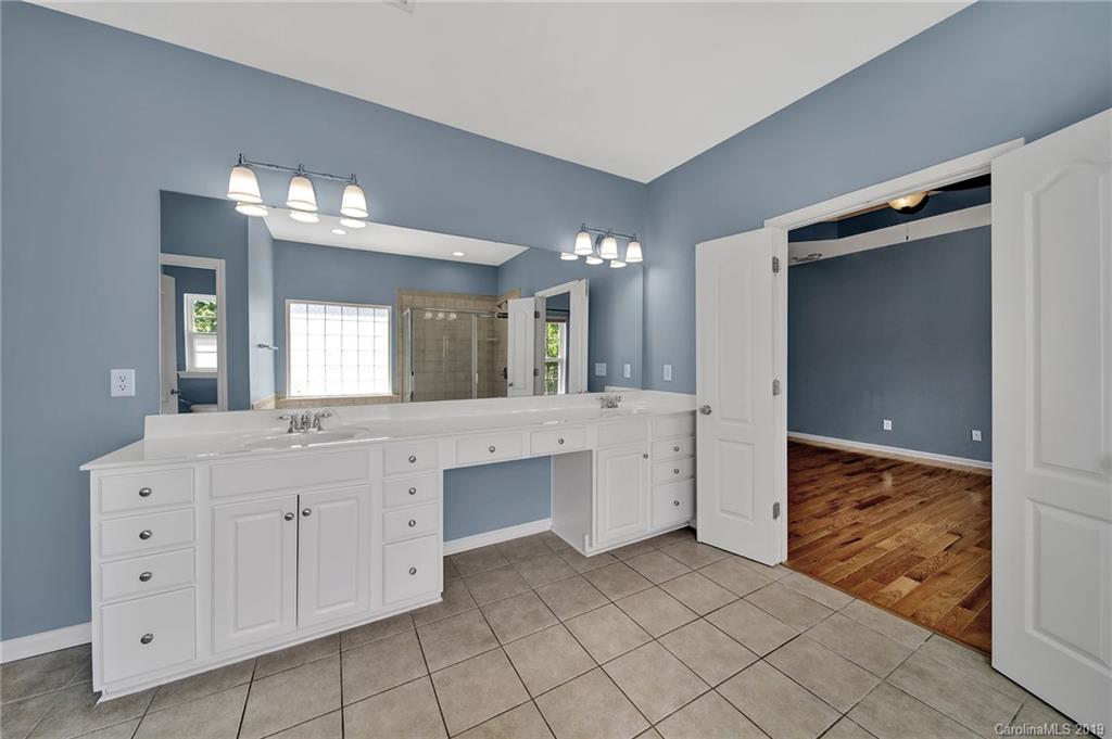 866 Treasure Court Fort Mill, SC 29708 - Photo 11 of 38 a large bathroom with a sink and a large mirror