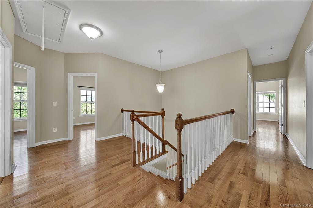 866 Treasure Court Fort Mill, SC 29708 - Photo 12 of 38 a view of a hallway with wooden floor and staircase