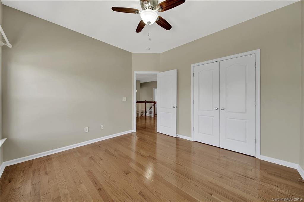 866 Treasure Court Fort Mill, SC 29708 - Photo 13 of 38 a view of empty room with wooden floor and ceiling fan