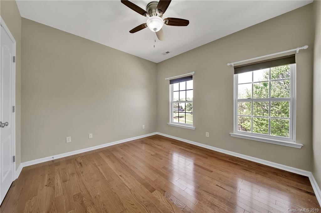 866 Treasure Court Fort Mill, SC 29708 - Photo 14 of 38 a view of an empty room with a window and wooden floor