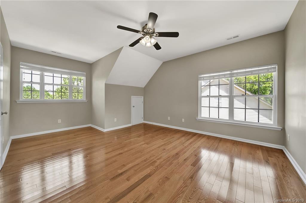866 Treasure Court Fort Mill, SC 29708 - Photo 17 of 38 an empty room with wooden floor fan and windows