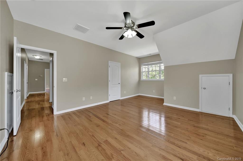 866 Treasure Court Fort Mill, SC 29708 - Photo 18 of 38 a view of empty room with wooden floor and fan