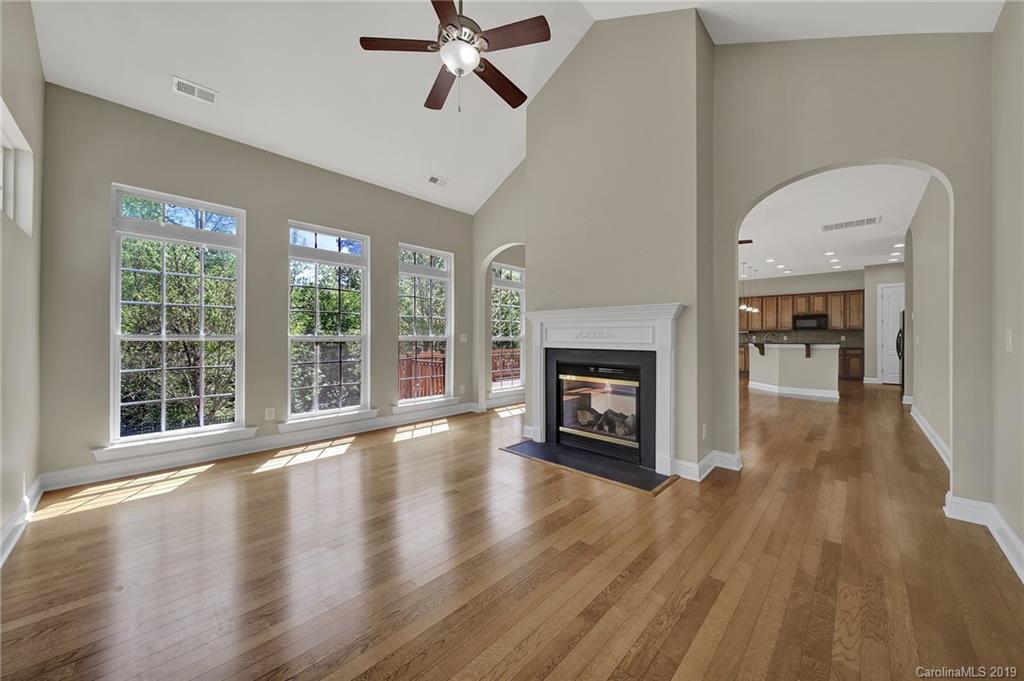 866 Treasure Court Fort Mill, SC 29708 - Photo 26 of 38 a view of a livingroom with wooden floor a fireplace and window