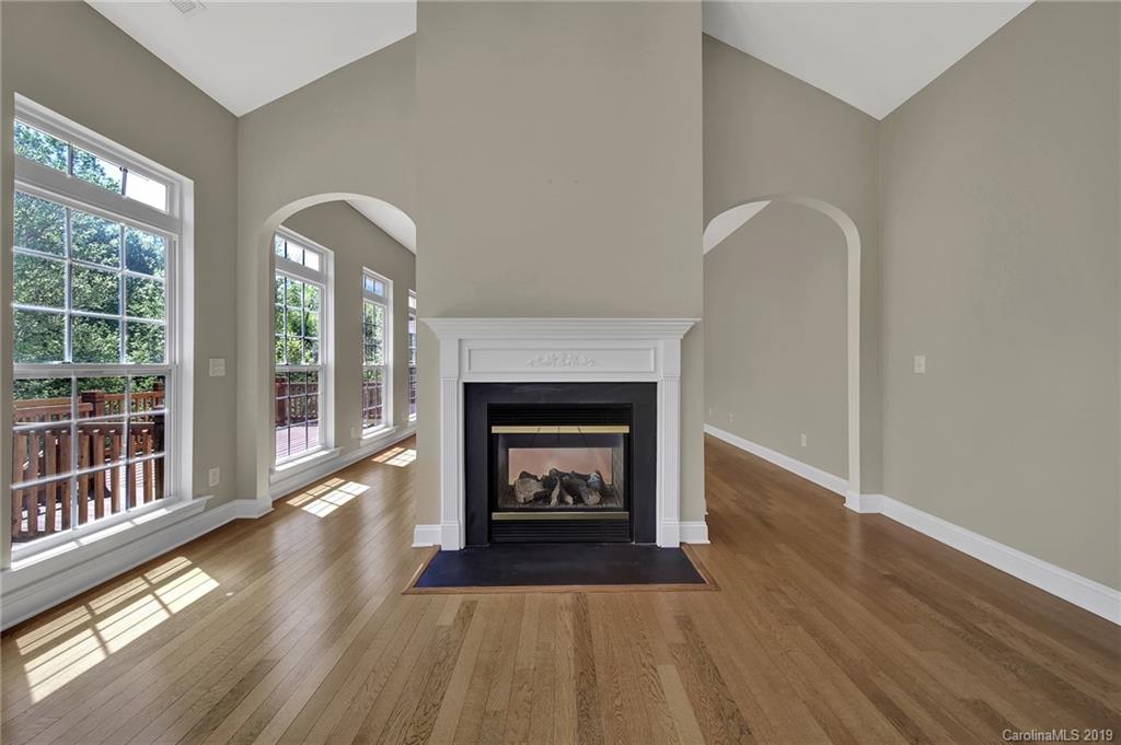 866 Treasure Court Fort Mill, SC 29708 - Photo 27 of 38 a living room with a fireplace and wooden floor