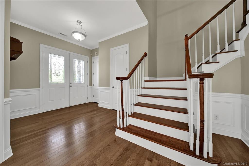 866 Treasure Court Fort Mill, SC 29708 - Photo 6 of 38 a view of front door with wooden floor and white walls